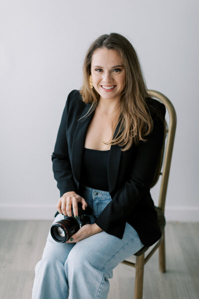 Picture of wedding photographer in Virginia holding camera.