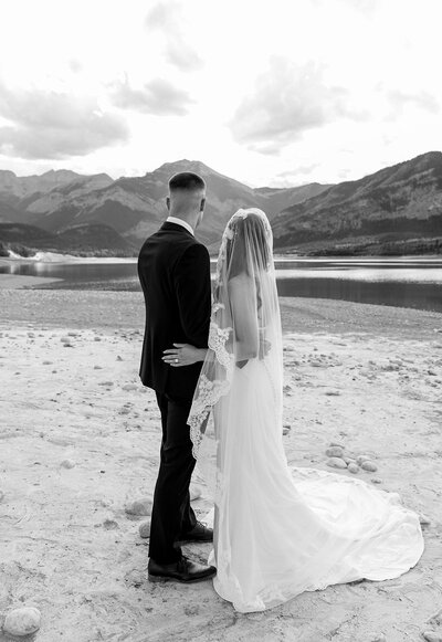 Romantic image of bride and groom on steps of building captured by luxury photographer Revel Photography