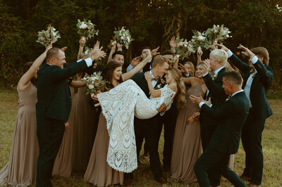 bridal party cheering on the bride and groom