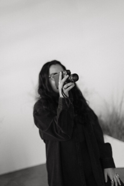 woman sitting down and holding camera