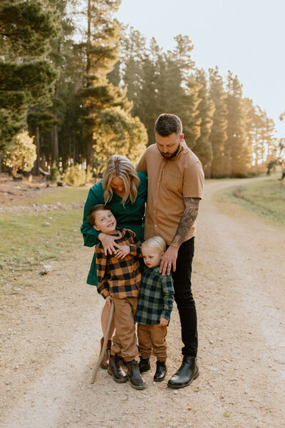 Far away photo of a family standing and cuddling