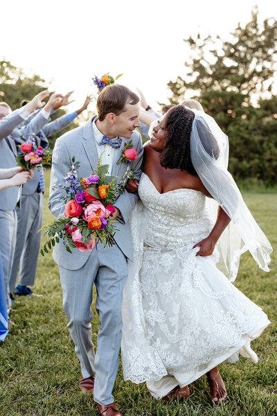 happy couple laughing at outdoor wedding reception