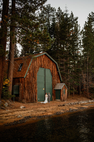 A wedding couple standing on the beach at Valhalla Lake Tahoe