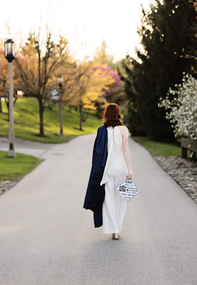 Photo of a graduate walking away from the camera