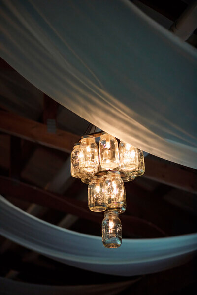 Hanging jar chandelier with rustic lighting
