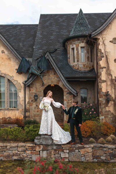 A bride and groom stand in front of the Chateau De Lis in Oregon City, OR