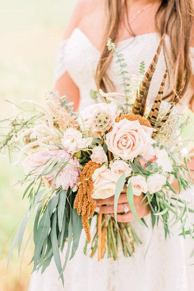 Boho bridal bouquet with dried flowers and feathers