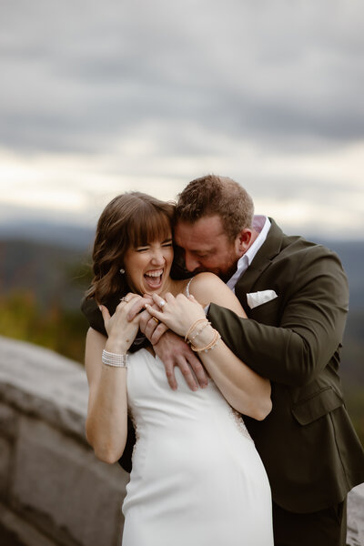 greenbrier elopement with bride and groom walking through the large river rocks with forests on either side of them for a candid wedding picture by photographers in gatlinburg tn