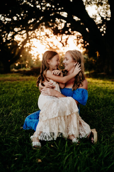 kneeling mommy and me pose with toddler girl at sunset in new Iberia, la