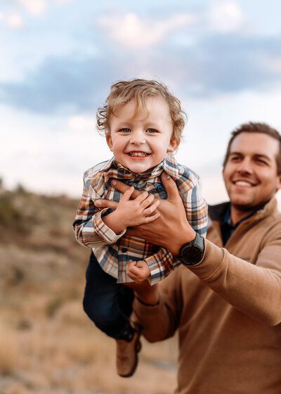 Siblings bonding with their newborn baby during a Denver family photo session