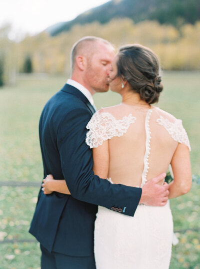 Couple kissing in front of mountain Denver Wedding Photographer