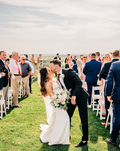 couple kissing at end of aisle - baltimore wedding photographer