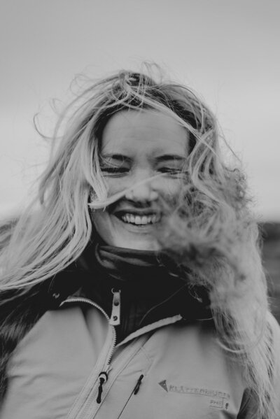 Woman with wind in her hair smiling