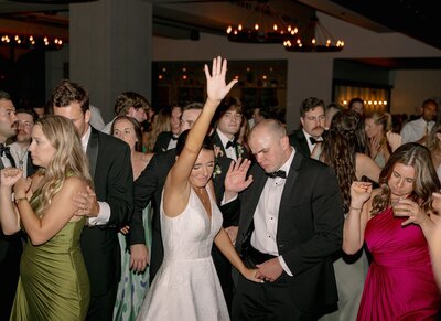 Guests dancing and celebrating at a lively wedding reception in Maine