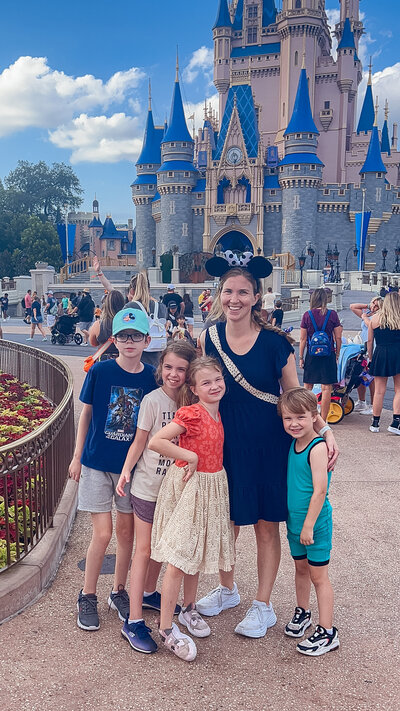Mom with four kids in front of Disney World Castle