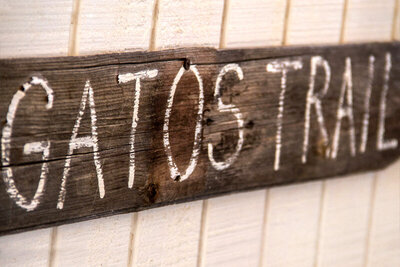 Location Branding Gatos Trail signage closeup wood sign on wood wall
