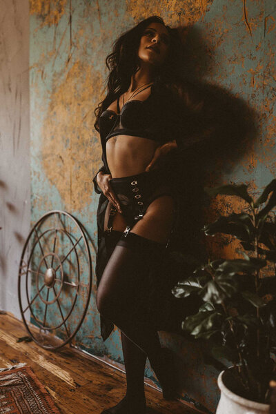 woman leaning on a wall