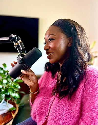 Image of Jill Dzadey, Melbourne couples therapist and founder of Freedom Couple Counselling, speaking into a podcast microphone as she participates in guest speaking