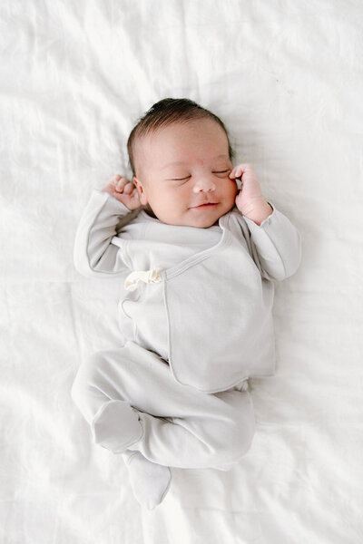 Baby boy sleeping on bed during in-home newborn photos with  Indianapolis Newborn Photographer, Capturing Simplicity Photography