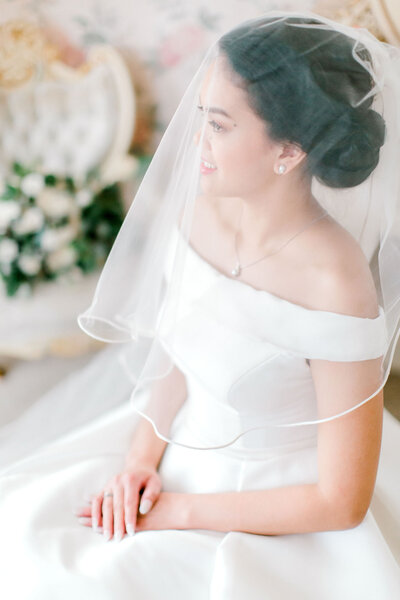 bride portrait sitting with veil
