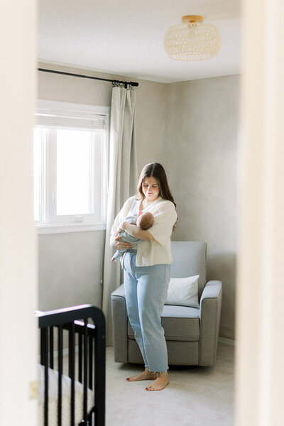 Woman holding baby in a nursery