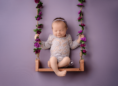 baby girl in swing newborn picture