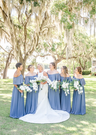 Bride with her bridesmaids on wedding day. black bridesmaid dresses