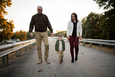 Toddler Boy walking in the sunset with his grandparents
