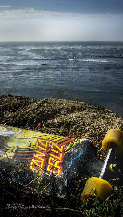 Orphaned Santa Cruz skateboard rests high above the surf at Pleasure Point, Santa Cruz, CA.