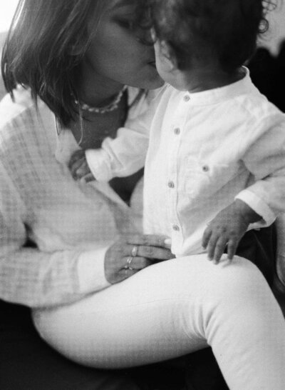 Woman kissing her young child