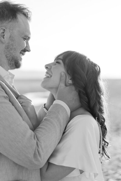 groom holding his bride's face about to go in for a kiss on the Salt Flats