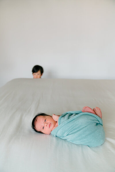 a newborn baby is swaddled on the bed
