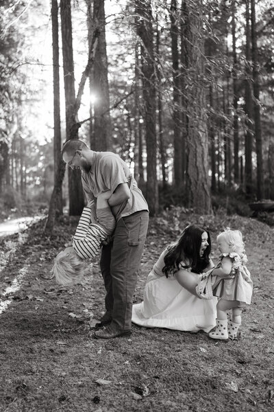 Woman sits in a field with a bouquet of yellow flowers