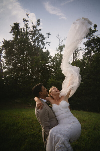 laughing bride being throw into air