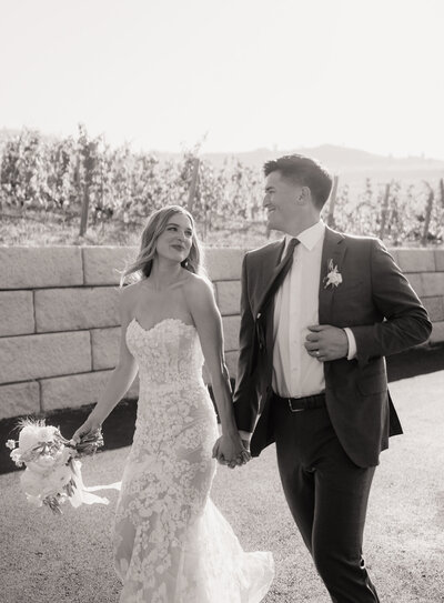 stunning bride and groom running with fashion forward details