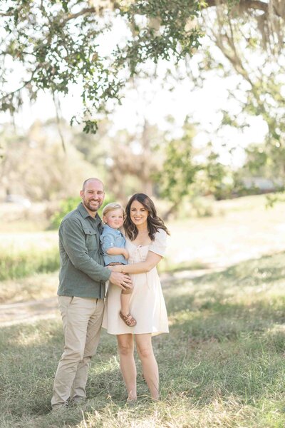 family of three pose together for houston mini session