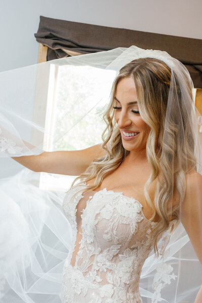 Yana adding final touch-up to bride’s makeup before ceremony in San Francisco wedding venue.

