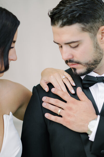 bride and groom touching hands at the nelson atkins in kansas city