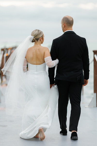 Bride and groom smiling on the pier at Baker’s Cay Resort, captured by Claudia Amalia, a wedding and lifestyle photographer based in Miami and Florida Keys, South Florida. Destination weddings available. Portfolio highlight.
