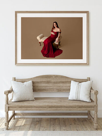 Framed maternity image of pregnant woman on a bench.