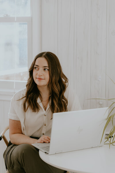 Rachel Haselwander, OBM and owner of Agera Business Services working on her laptop