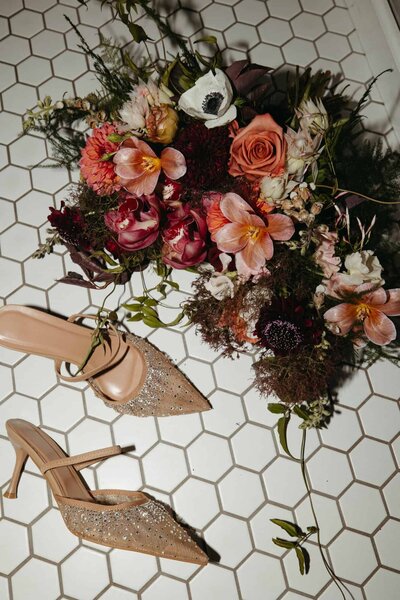 A pink summer time themed bouquet with bridal heels 