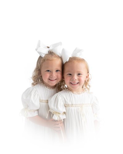 Twin girls in heirloom white dresses in Savannah, GA