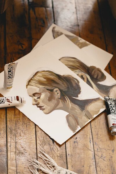 Painting of Steph Fuerst with art supplies