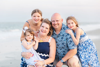 happy family snuggling at the beach