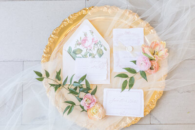 Grey Loft Studio - Bethany and Luc Barette - Wedding Photography Wedding Videography Ottawa - Houston wedding focus on wedding invitations on gold charger plate flatlay