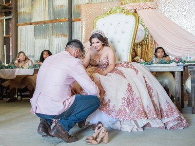 Quinceañera changing her shoes during reception