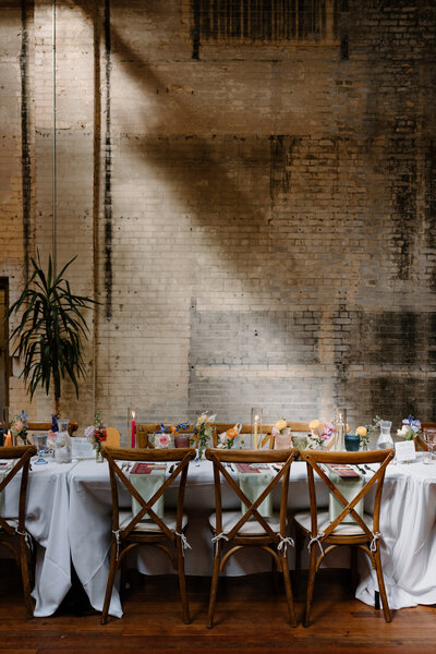 A wedding reception table set up in an industrial style room 
