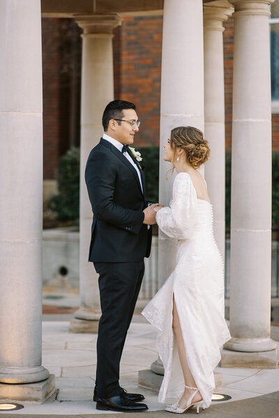 bride and groom holding hands during first look