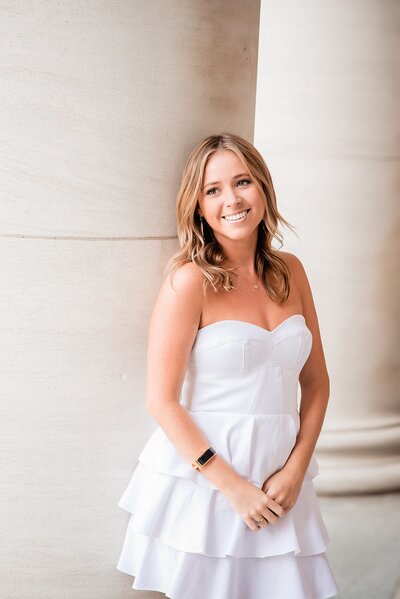 KKG Vanderbilt  senior leaning against the wall outside the Wyatt Center